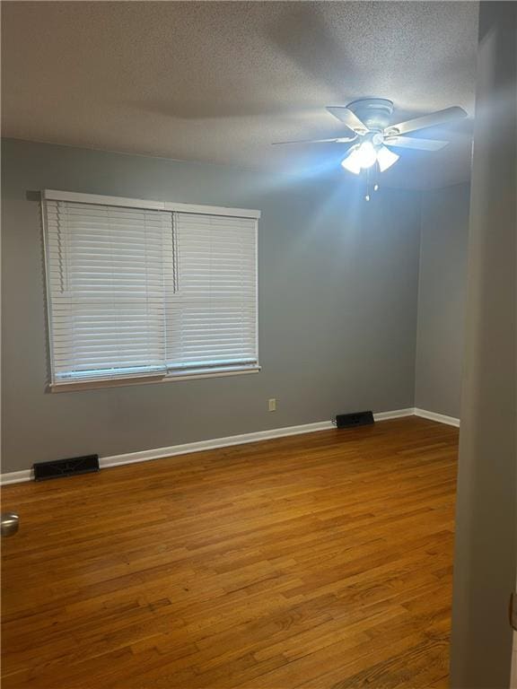 1923 Seneca St, Leavenworth, KS 66048 - spare room featuring wood finished floors, ceiling fan, and a textured ceiling