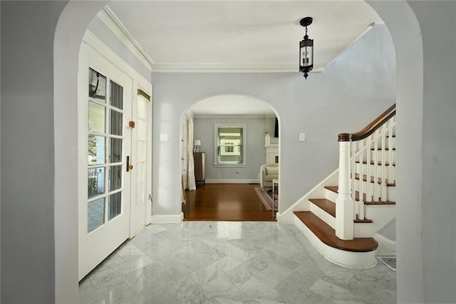 35 W 70th St, Kansas City, MO 64113 - foyer entrance featuring arched walkways, ornamental molding, marble finish floors, and stairs
