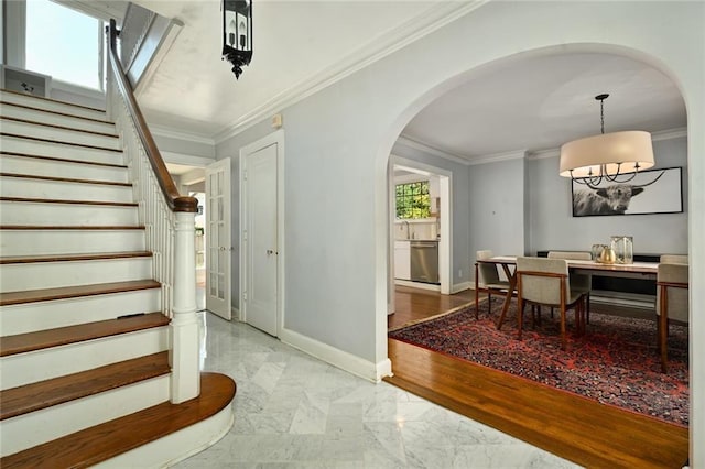 35 W 70th St, Kansas City, MO 64113 - foyer entrance with marble finish floors, stairway, crown molding, and arched walkways