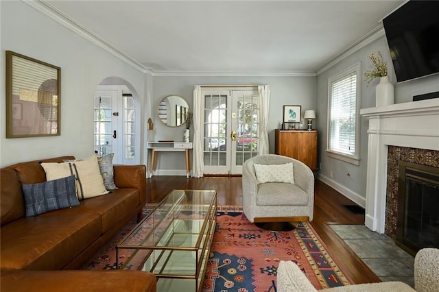 35 W 70th St, Kansas City, MO 64113 - living room with crown molding, french doors, wood finished floors, arched walkways, and a fireplace