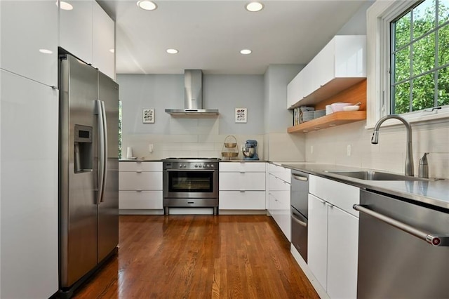 35 W 70th St, Kansas City, MO 64113 - kitchen with stainless steel appliances, wall chimney exhaust hood, modern cabinets, backsplash, and recessed lighting