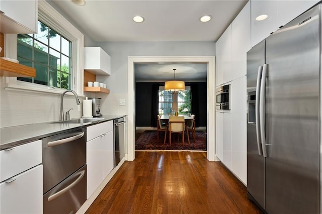 35 W 70th St, Kansas City, MO 64113 - kitchen featuring stainless steel appliances, white cabinetry, dark wood-type flooring, modern cabinets, and recessed lighting
