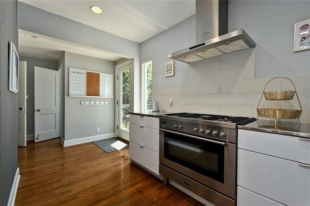 35 W 70th St, Kansas City, MO 64113 - kitchen featuring high end range, wall chimney exhaust hood, tasteful backsplash, white cabinetry, and dark wood-style flooring
