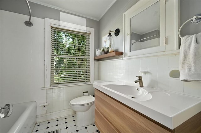 35 W 70th St, Kansas City, MO 64113 - bathroom with tile walls, crown molding, vanity, plenty of natural light, and tile patterned floors