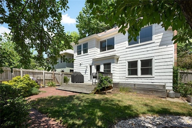 35 W 70th St, Kansas City, MO 64113 - rear view of house featuring a fenced backyard and a deck
