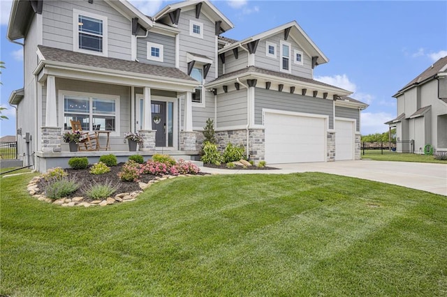 16352 S Elmridge St, Olathe, KS 66062 - view of front of home with concrete driveway, stone siding, covered porch, and a garage