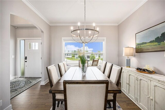 16352 S Elmridge St, Olathe, KS 66062 - dining space with a chandelier, dark wood-type flooring, arched walkways, crown molding, and baseboards