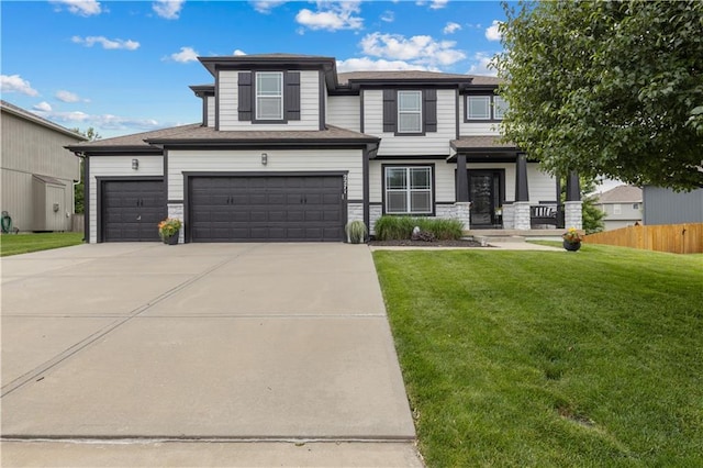 2271 W Loula St, Olathe, KS 66061 - view of front of house with driveway, stone siding, and a garage