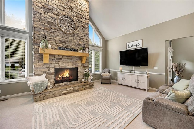 15417 Poplar St, Basehor, KS 66007 - carpeted living room with high vaulted ceiling, baseboards, and a stone fireplace