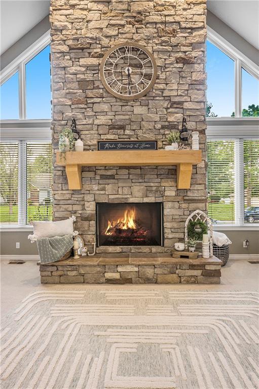 15417 Poplar St, Basehor, KS 66007 - detailed view of carpet flooring, baseboards, and a stone fireplace
