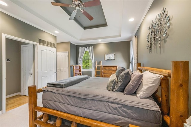 15417 Poplar St, Basehor, KS 66007 - bedroom featuring a tray ceiling, recessed lighting, wood finished floors, baseboards, and a ceiling fan