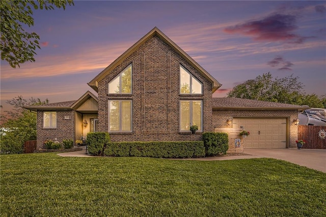 15417 Poplar St, Basehor, KS 66007 - view of front of house with concrete driveway, a garage, and brick siding