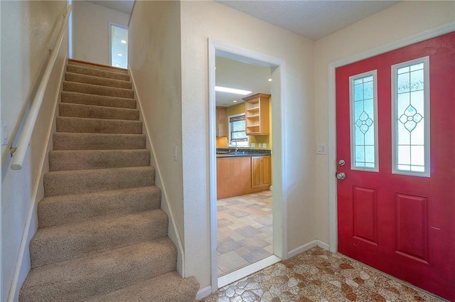 8811 W 66th Ter, Mission, KS 66202 - entryway featuring stairs, plenty of natural light, and baseboards
