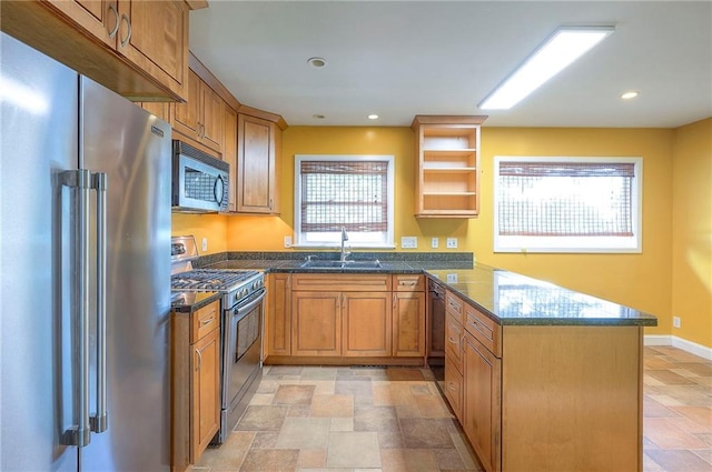 8811 W 66th Ter, Mission, KS 66202 - kitchen featuring appliances with stainless steel finishes, stone finish floors, a peninsula, a sink, and plenty of natural light