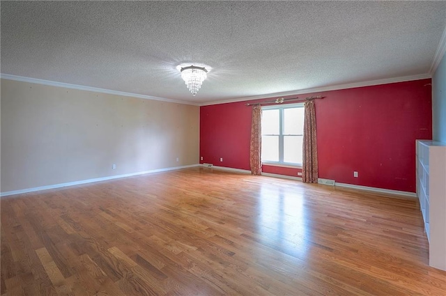 8811 W 66th Ter, Mission, KS 66202 - unfurnished room with crown molding, light wood finished floors, a textured ceiling, and baseboards