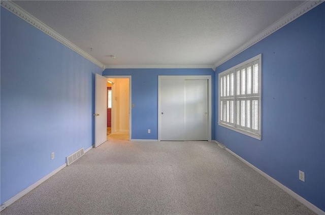 8811 W 66th Ter, Mission, KS 66202 - unfurnished bedroom featuring ornamental molding, carpet, a closet, a textured ceiling, and baseboards
