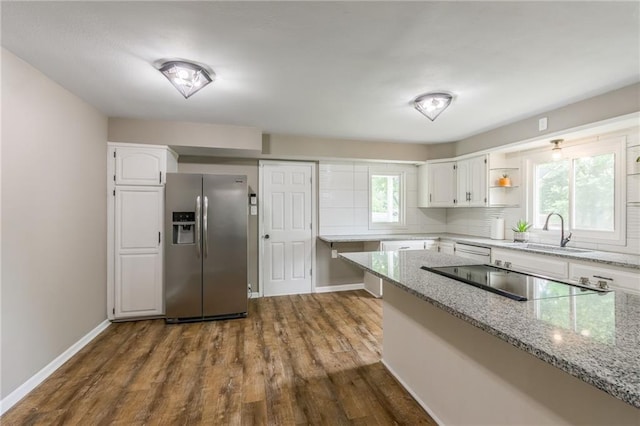 10100 E Sheley Rd, Independence, MO 64052 - kitchen featuring stainless steel fridge, a sink, black electric stovetop, white cabinetry, and light stone counters