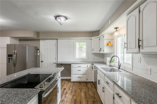 10100 E Sheley Rd, Independence, MO 64052 - kitchen with stainless steel appliances, a sink, light stone countertops, white cabinetry, and wood finished floors