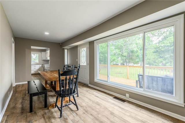 10100 E Sheley Rd, Independence, MO 64052 - dining area with baseboards, light wood finished floors, healthy amount of natural light, and recessed lighting
