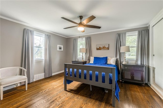10100 E Sheley Rd, Independence, MO 64052 - bedroom with wood finished floors, multiple windows, crown molding, and baseboards