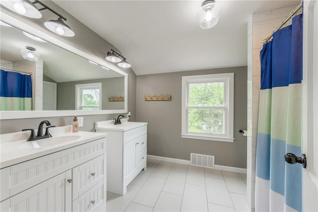 10100 E Sheley Rd, Independence, MO 64052 - bathroom with lofted ceiling, two vanities, tile patterned floors, baseboards, and curtained shower