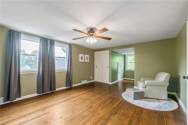 10100 E Sheley Rd, Independence, MO 64052 - living area with a ceiling fan, wood finished floors, and baseboards