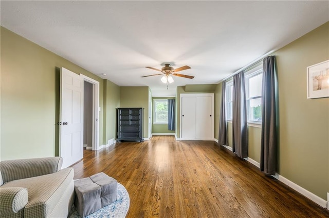 10100 E Sheley Rd, Independence, MO 64052 - living area featuring wood finished floors, baseboards, and a ceiling fan