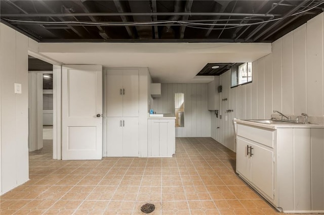 10100 E Sheley Rd, Independence, MO 64052 - kitchen featuring light countertops, a sink, white cabinets, and wooden walls