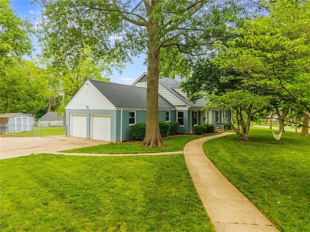 10100 E Sheley Rd, Independence, MO 64052 - view of front facade featuring driveway, roof with shingles, a garage, and a storage shed