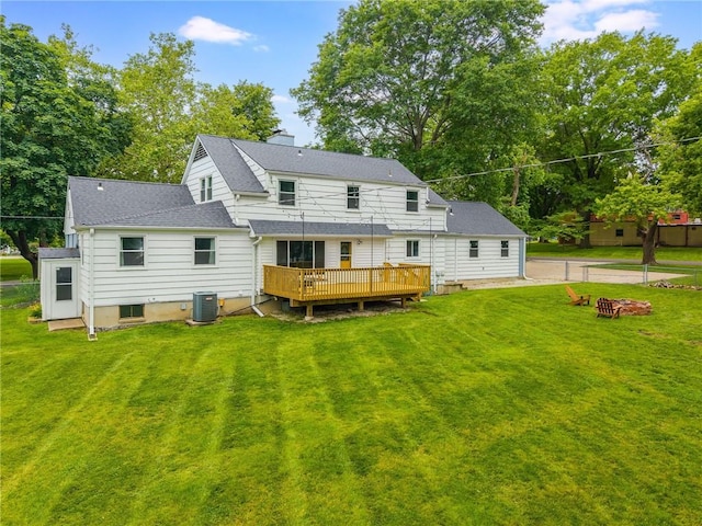 10100 E Sheley Rd, Independence, MO 64052 - rear view of property featuring a wooden deck, an outdoor fire pit, a yard, and roof with shingles