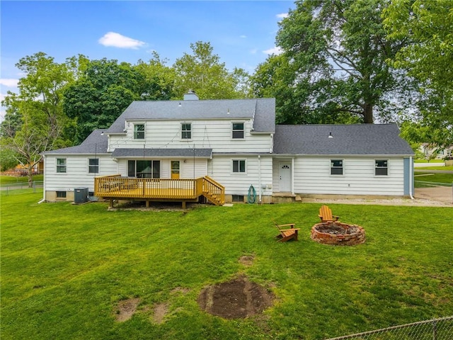 10100 E Sheley Rd, Independence, MO 64052 - back of property featuring a wooden deck, an outdoor fire pit, central AC unit, and a lawn