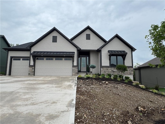 22428 W 90th Ter, Lenexa, KS 66227 - view of front facade featuring stone siding, a garage, driveway, and a standing seam roof