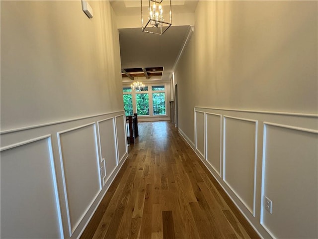 22428 W 90th Ter, Lenexa, KS 66227 - hallway featuring a chandelier, coffered ceiling, dark wood-style flooring, a decorative wall, and beam ceiling