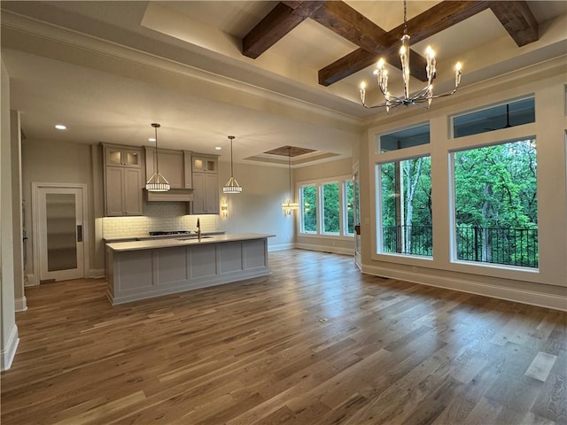 22428 W 90th Ter, Lenexa, KS 66227 - kitchen featuring baseboards, open floor plan, a chandelier, backsplash, and gray cabinetry