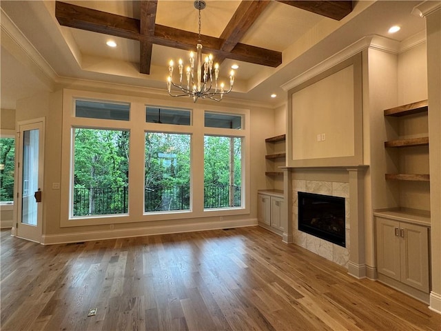 22428 W 90th Ter, Lenexa, KS 66227 - unfurnished living room with plenty of natural light, coffered ceiling, a chandelier, a tile fireplace, and wood finished floors