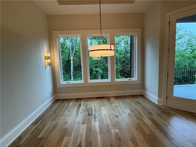 22428 W 90th Ter, Lenexa, KS 66227 - unfurnished dining area featuring wood finished floors and baseboards