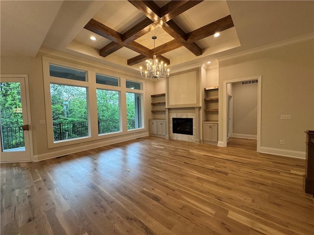 22428 W 90th Ter, Lenexa, KS 66227 - unfurnished living room with plenty of natural light, a chandelier, coffered ceiling, baseboards, and wood finished floors