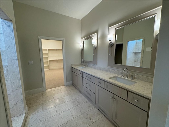 22428 W 90th Ter, Lenexa, KS 66227 - bathroom featuring double vanity, baseboards, a spacious closet, and tile patterned flooring