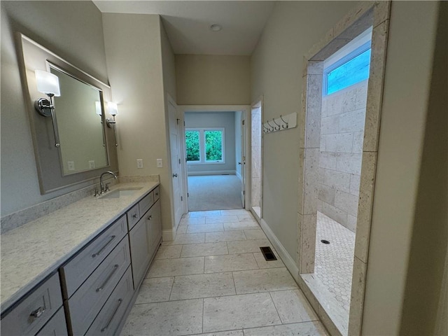 22428 W 90th Ter, Lenexa, KS 66227 - bathroom featuring a walk in shower, vanity, baseboards, and tile patterned floors