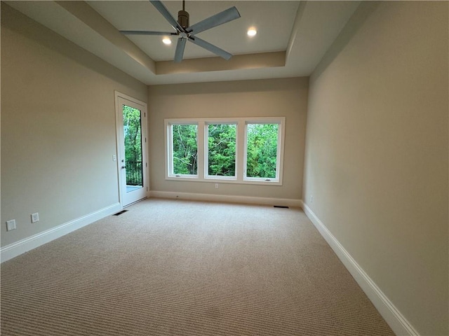 22428 W 90th Ter, Lenexa, KS 66227 - carpeted spare room featuring a ceiling fan, baseboards, recessed lighting, and a tray ceiling