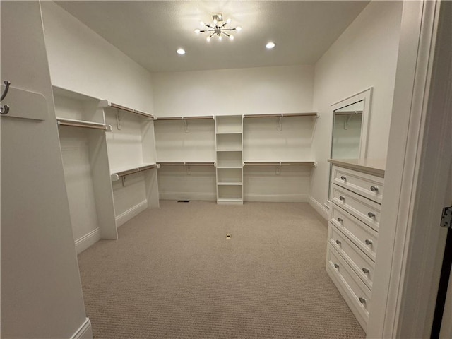 22428 W 90th Ter, Lenexa, KS 66227 - walk in closet featuring light carpet and a chandelier