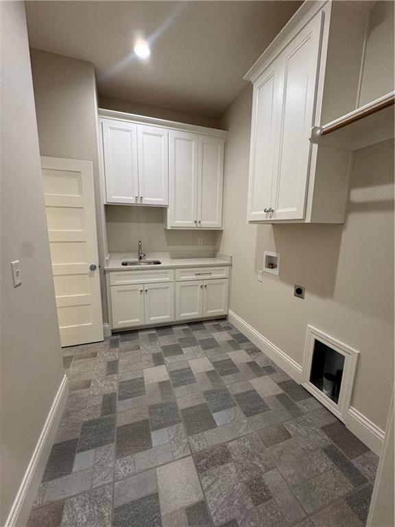 22428 W 90th Ter, Lenexa, KS 66227 - laundry room featuring cabinet space, baseboards, hookup for an electric dryer, and hookup for a washing machine