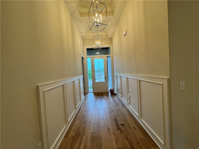 22428 W 90th Ter, Lenexa, KS 66227 - corridor with a chandelier, a decorative wall, dark wood finished floors, wainscoting, and a tray ceiling