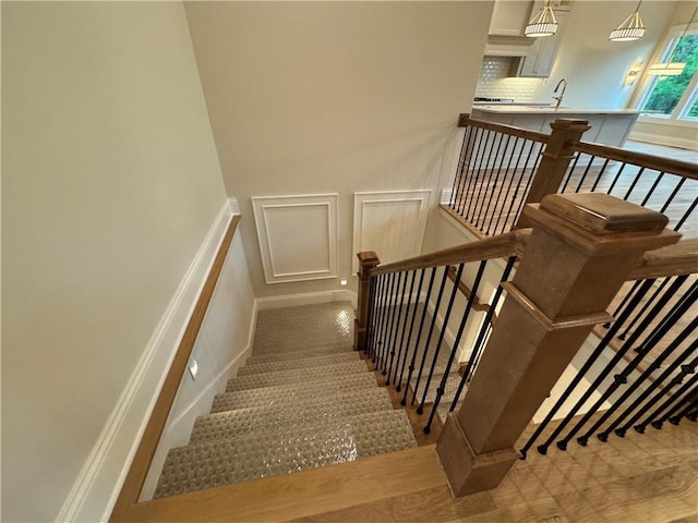 22428 W 90th Ter, Lenexa, KS 66227 - stairs featuring a decorative wall and a wainscoted wall