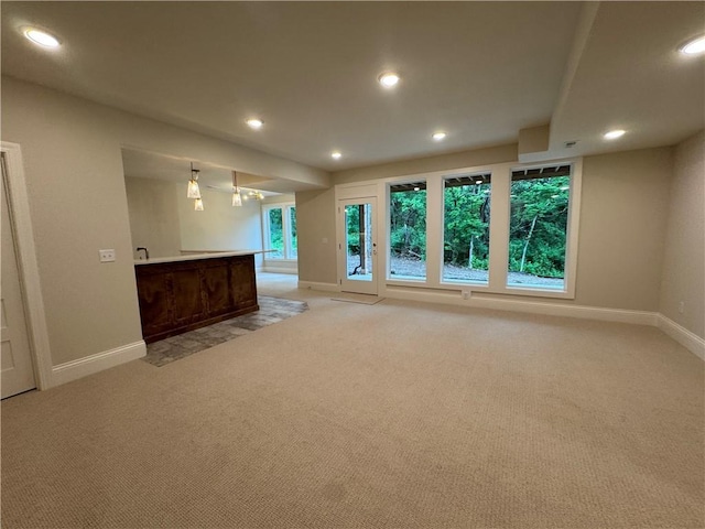 22428 W 90th Ter, Lenexa, KS 66227 - unfurnished living room with baseboards, light carpet, and recessed lighting