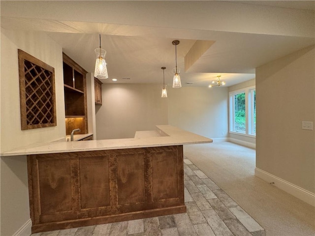 22428 W 90th Ter, Lenexa, KS 66227 - indoor wet bar featuring baseboards, pendant lighting, and light colored carpet