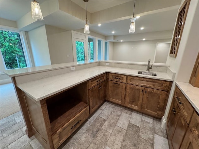 22428 W 90th Ter, Lenexa, KS 66227 - kitchen with a sink, stone tile floors, light stone counters, hanging light fixtures, and recessed lighting