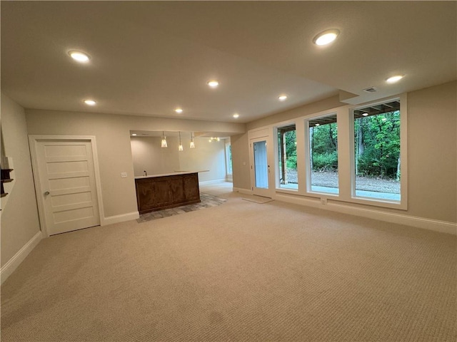 22428 W 90th Ter, Lenexa, KS 66227 - unfurnished living room with light carpet, recessed lighting, wet bar, and baseboards