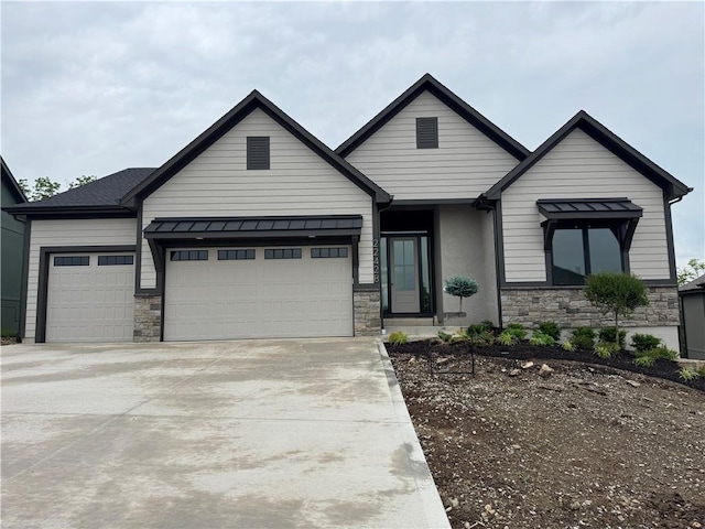 22428 W 90th Ter, Lenexa, KS 66227 - view of front facade featuring stone siding, an attached garage, and driveway