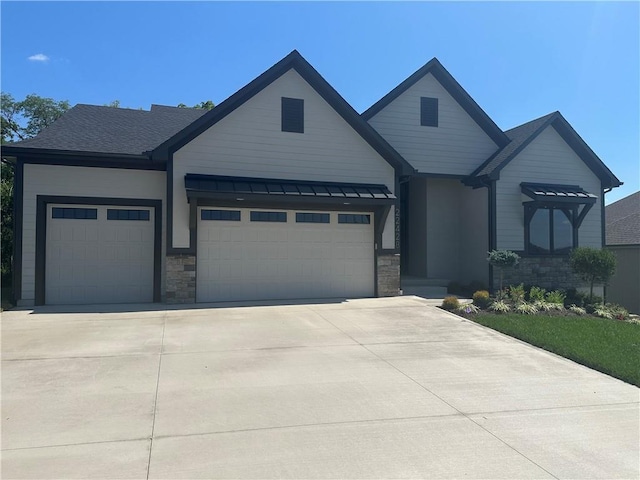 22428 W 90th Ter, Lenexa, KS 66227 - view of front facade with an attached garage, stone siding, and concrete driveway